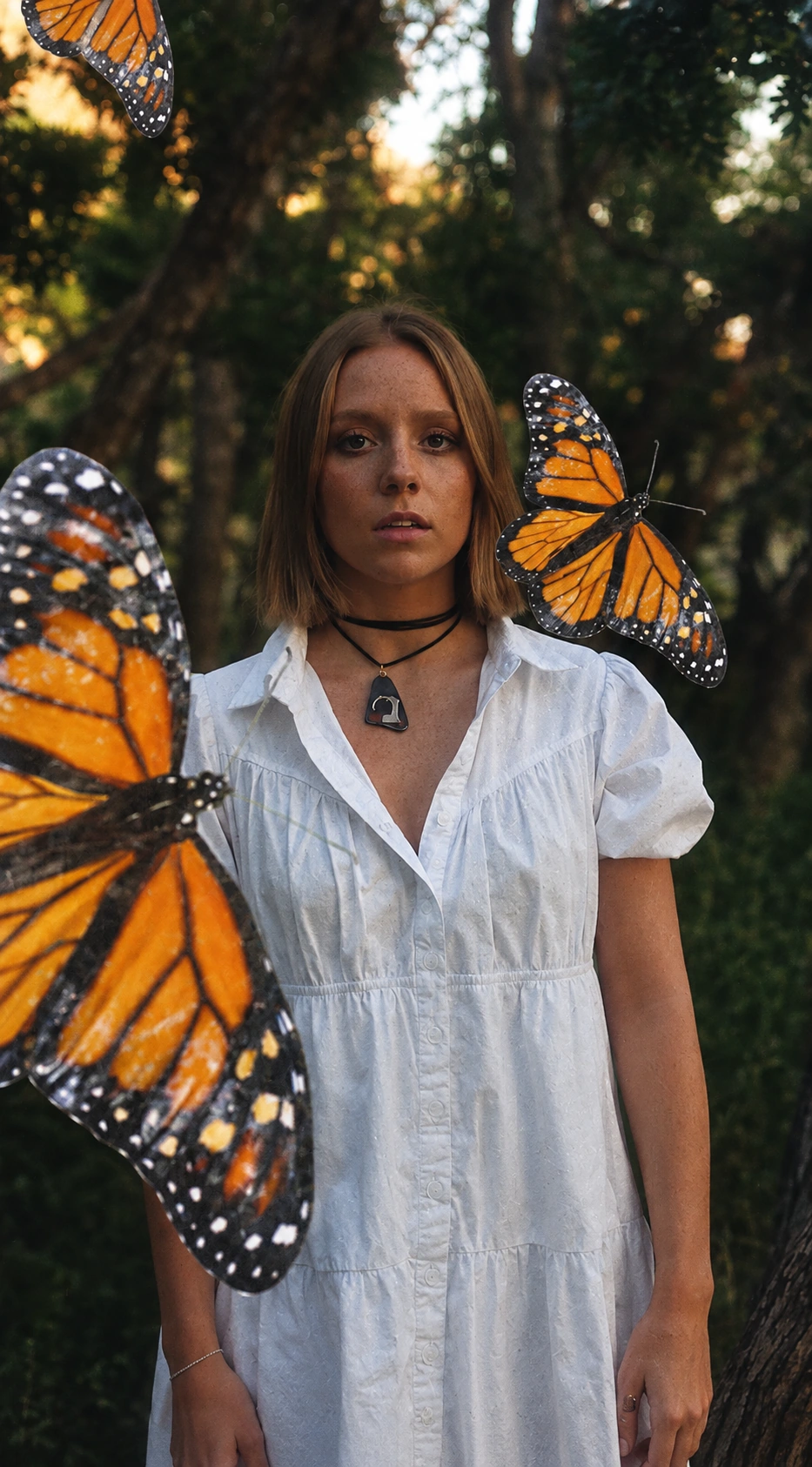 Editorial portrait surrounded by monarch butterflies